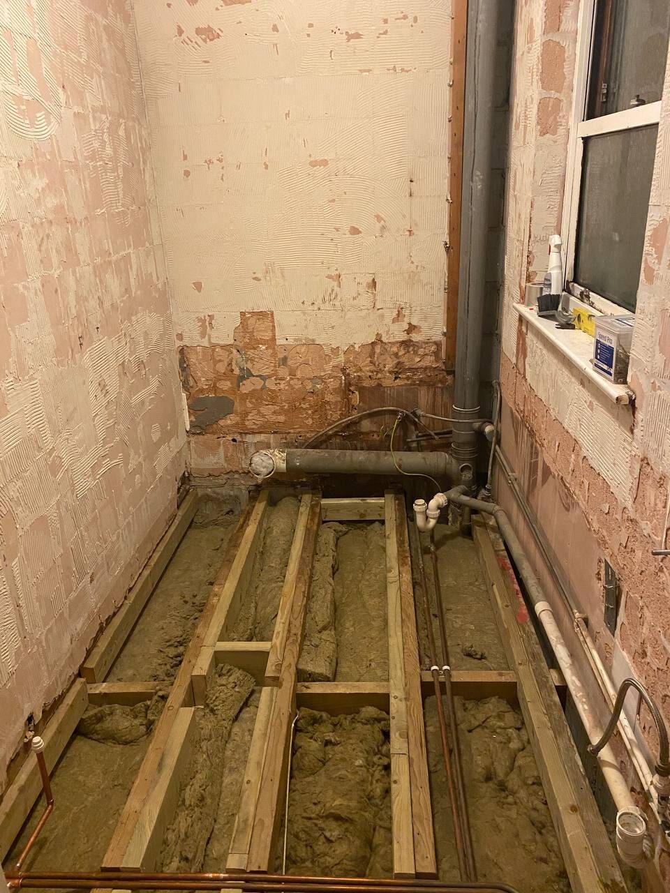 Bathroom floor lifted to joist level with new copper and waste pipework installed