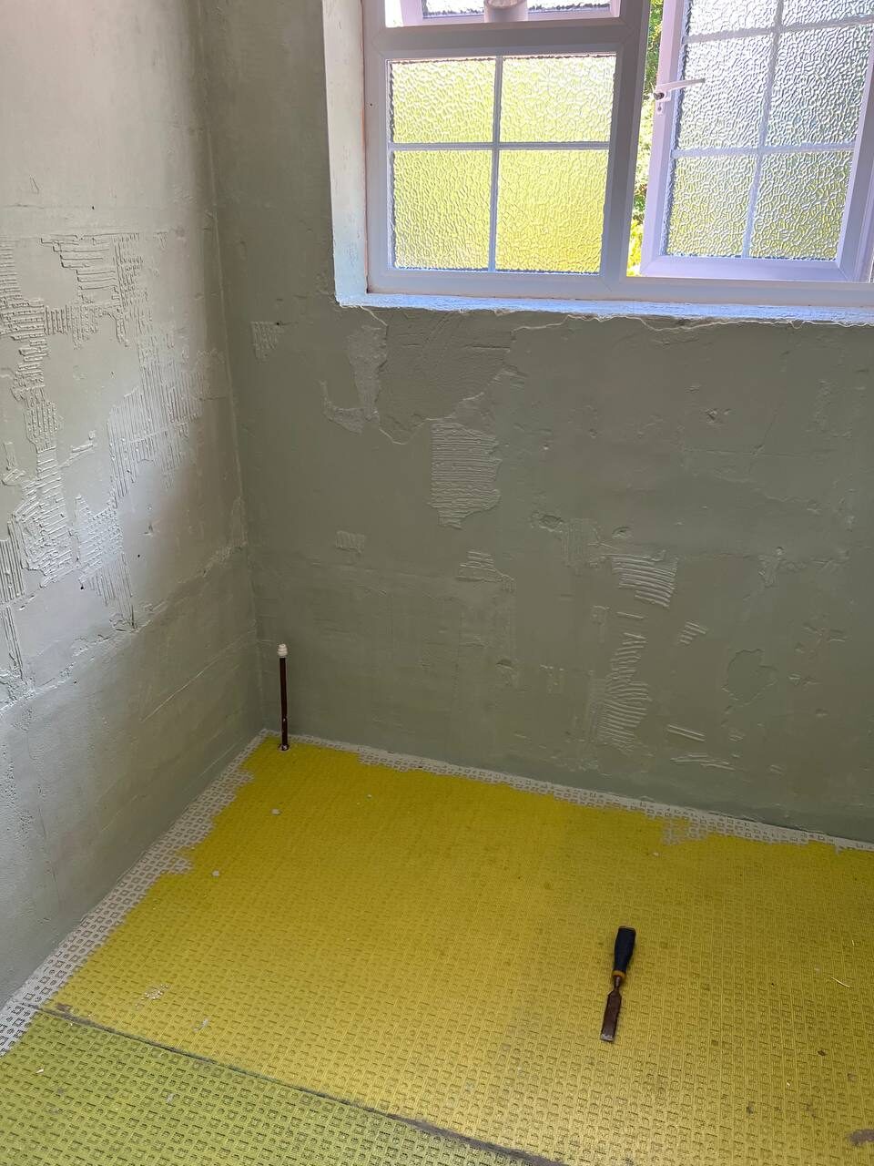 Room stripped back with the subfloor prepared ahead of tiling